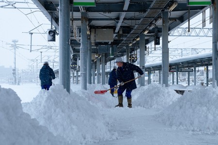 Hakodate City, Japan, December, 22th, 2009: Hakodate Station worker shoveling snowのeditorial素材