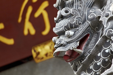Head of dragon carving sandstone with horizontal inscribed board background in Chinese Temple,Close upの写真素材