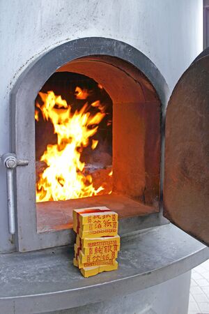 Asian girl burns joss papers