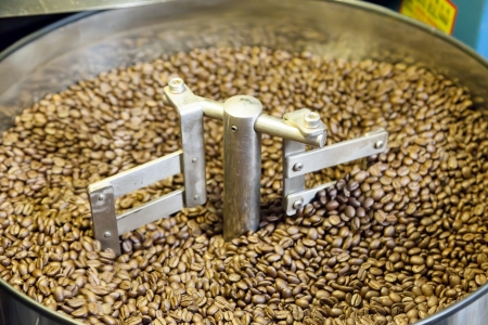 cools roasted coffee beans in roasting machine close upの写真素材