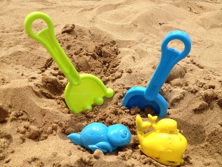 Childs toys with sand on beach の素材