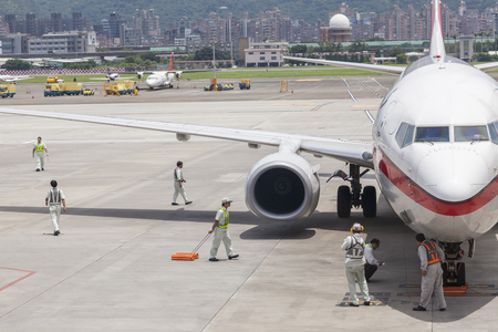 Airport ground handing operations on tarmac in Taipei SongShan Airportのeditorial素材