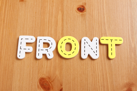 FRONT, spell by woody puzzle letters with woody backgroundの写真素材