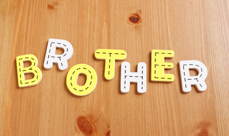 BROTHER, spell by woody puzzle letters with woody backgroundの写真素材