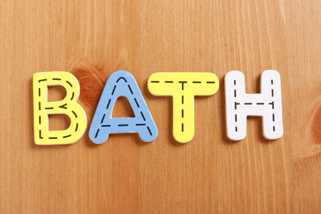 BATH, spell by woody puzzle letters with woody backgroundの写真素材