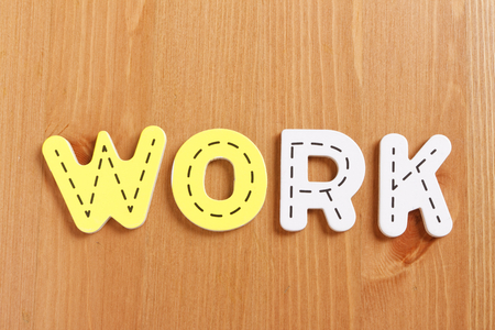 WORK, spell by woody puzzle letters with woody backgroundの写真素材