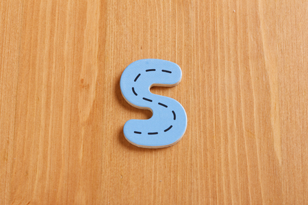 S, spell by woody puzzle letters with woody backgroundの写真素材