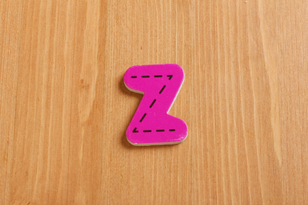Z,spell by woody puzzle letters with woody backgroundの写真素材