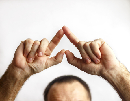 A man shows heart on a white backgroundの写真素材