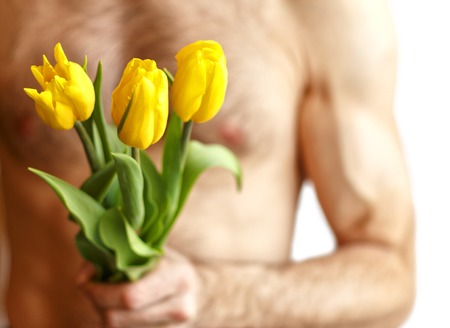 A man holding tulips. Isolated on whiteの写真素材