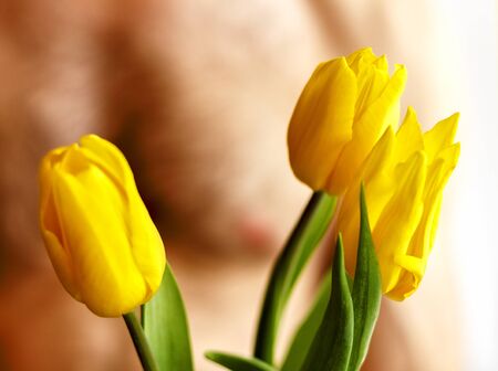 A man holding tulips. Isolated on whiteの写真素材