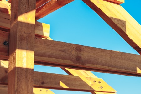 New residential construction home framing against a blue skyの写真素材