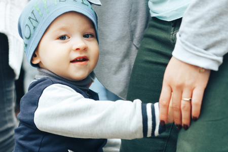 MINSK, BELARUS.JULY 29 2017 Beautiful boy on a walk in the city with his parents in a fashionable clothes. father holds his handのeditorial素材