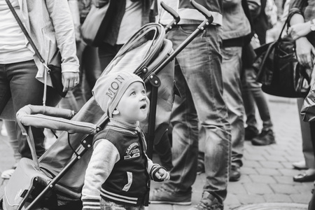 MINSK, BELARUS.JULY 29 2017 Beautiful boy on a walk in the city with his parents in a fashionable clothes. father holds his handのeditorial素材