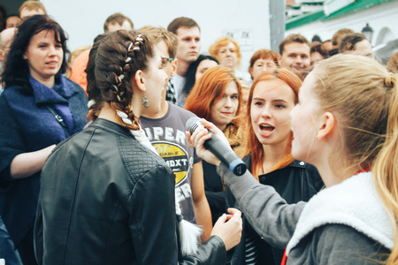 MINSK, BELARUS.JULY 29, 2017. Woman with a microphone sings on the street