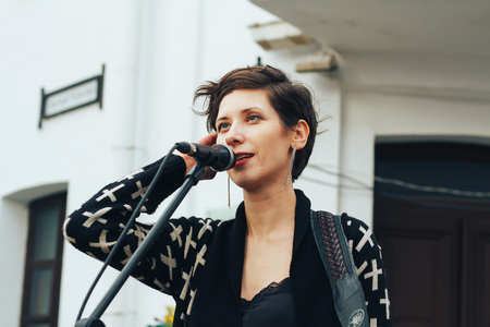 MINSK, BELARUS.JULY 29, 2017. Woman with a microphone sings on the street