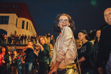 MINSK, BELARUS.JULY 29, 2017. Afro man sings and dances at night on the streetのeditorial素材