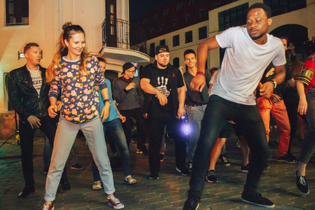 MINSK, BELARUS.JULY 29, 2017. Afro man sings and dances at night on the streetのeditorial素材
