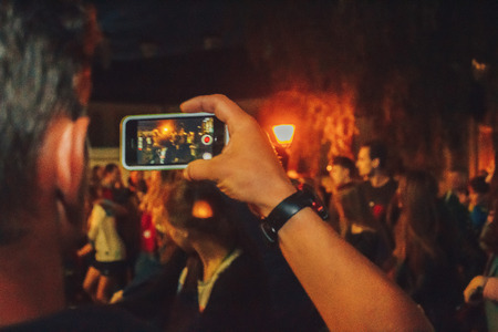 MINSK, BELARUS.JULY 29, 2017. Afro man sings and dances at night on the streetのeditorial素材