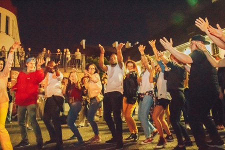 MINSK, BELARUS.JULY 29, 2017. Afro man sings and dances at night on the streetのeditorial素材