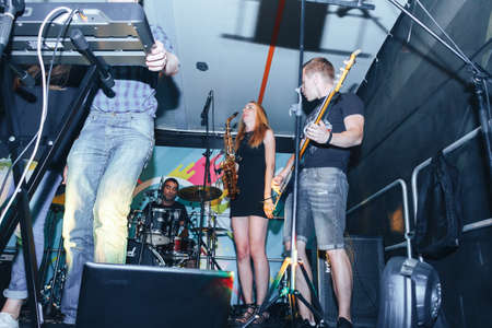 MINSK, BELARUS.August 5, 2017. Band performs on stage, rock music concert. Warning - authentic shooting with high iso in challenging lighting conditions. A little bit grain and blurred motion effects.のeditorial素材