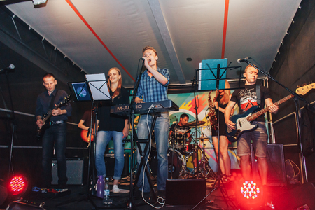 MINSK, BELARUS.August 5, 2017. Band performs on stage, rock music concert. Warning - authentic shooting with high iso in challenging lighting conditions. A little bit grain and blurred motion effects.のeditorial素材
