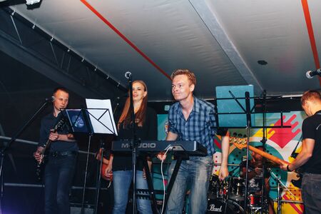 MINSK, BELARUS.August 5, 2017. Band performs on stage, rock music concert. Warning - authentic shooting with high iso in challenging lighting conditions. A little bit grain and blurred motion effects.のeditorial素材