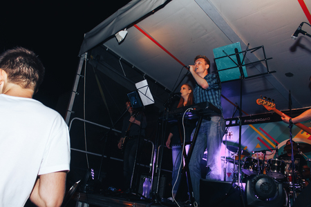 MINSK, BELARUS.August 5, 2017. Band performs on stage, rock music concert. Warning - authentic shooting with high iso in challenging lighting conditions. A little bit grain and blurred motion effects.のeditorial素材