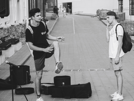 MINSK, BELARUS.August 12, 2017 Two guys talking on the streetのeditorial素材