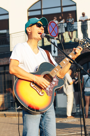 MINSK, BELARUS.August 19, 2017. A man with a guitar sings on the streetのeditorial素材