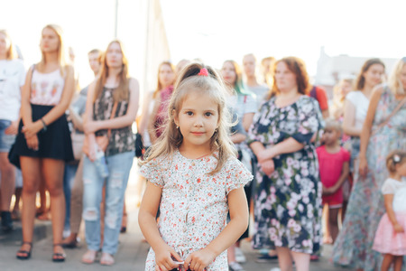 MINSK, BELARUS.JULY 29, 2017 Little girl looks on the streetのeditorial素材