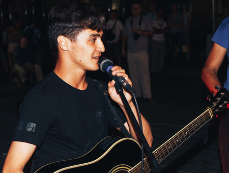 MINSK, BELARUS.August 19, 2017. A man with a guitar sings on the streetのeditorial素材