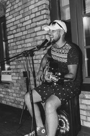 MINSK, BELARUS.August 19, 2017. A man with a guitar sings on the streetのeditorial素材