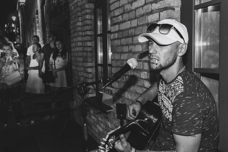 MINSK, BELARUS.August 19, 2017. A man with a guitar sings on the streetのeditorial素材