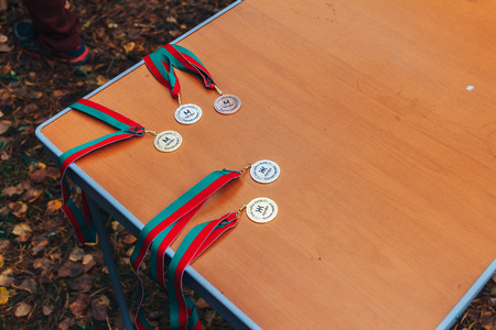 Sports medals lie on the table in the streetの写真素材