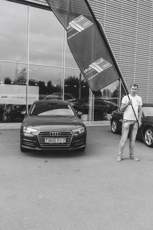 MINSK, BELARUS.August 26, 2017. Test drive audi. A man is showing a flagのeditorial素材