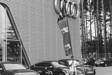 MINSK, BELARUS.August 26, 2017. Test drive audi. A man is showing a flagのeditorial素材