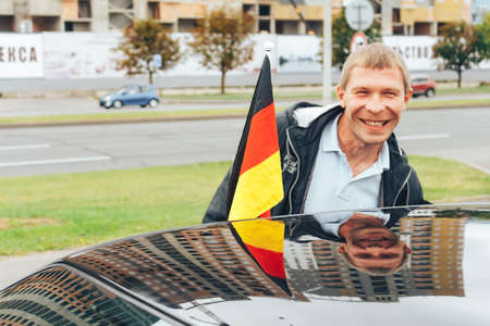 MINSK, BELARUS.August 26, 2017. Test drive audi. A man is showing a flagのeditorial素材