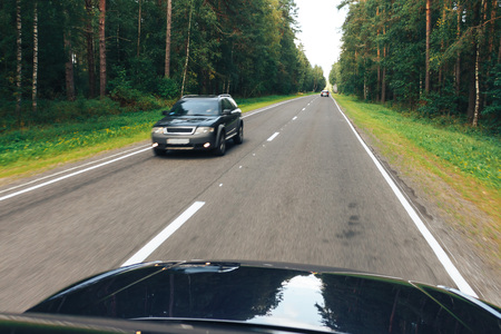 The car is driving along the roadの写真素材