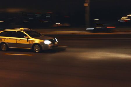 The car is driving along the road. Long exposure. Blurred backgroundの写真素材
