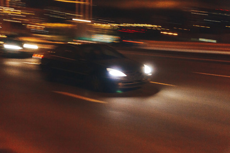 The car is driving along the road. Long exposure. Blurred backgroundの写真素材