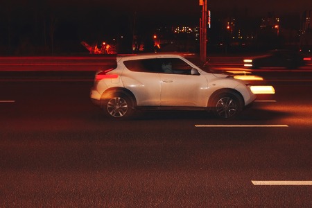 The car is driving along the road. Long exposure. Blurred backgroundの写真素材