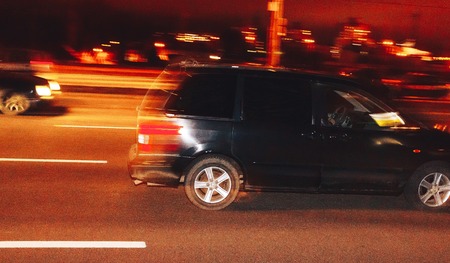 The car is driving along the road. Long exposure. Blurred backgroundの写真素材
