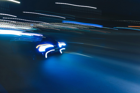 The car is driving along the road. Long exposure. Blurred backgroundの写真素材
