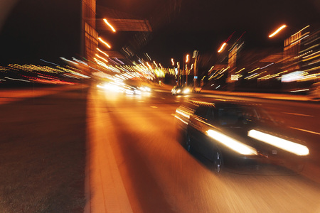 The car is driving along the road. Long exposure. Blurred backgroundの写真素材