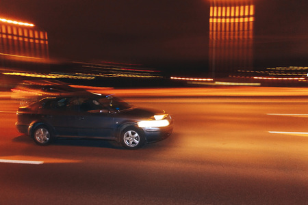 The car is driving along the road. Long exposure. Blurred backgroundの写真素材