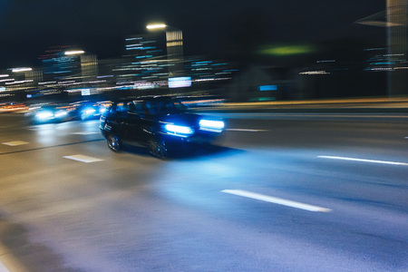 The car is driving along the road. Long exposure. Blurred backgroundの写真素材