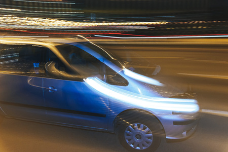The car is driving along the road. Long exposure. Blurred backgroundの写真素材