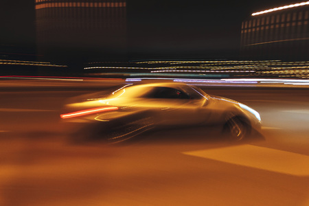 The car is driving along the road. Long exposure. Blurred backgroundの写真素材