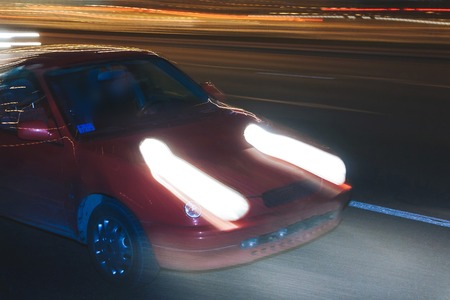 The car is driving along the road. Long exposure. Blurred backgroundの写真素材